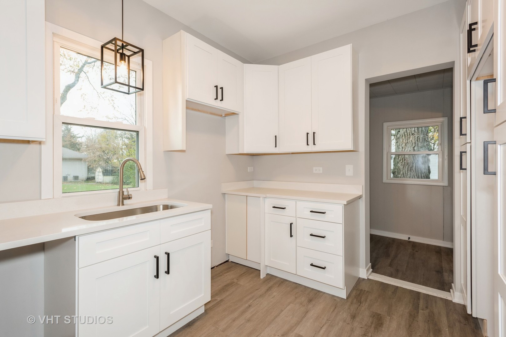 381 Sullivan Road North Aurora, IL 60542 - Photo 12 of 29 a kitchen with white cabinets and window
