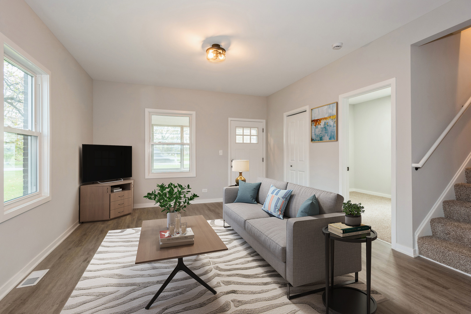 381 Sullivan Road North Aurora, IL 60542 - Photo 7 of 29 a living room with furniture a flat screen tv and a window