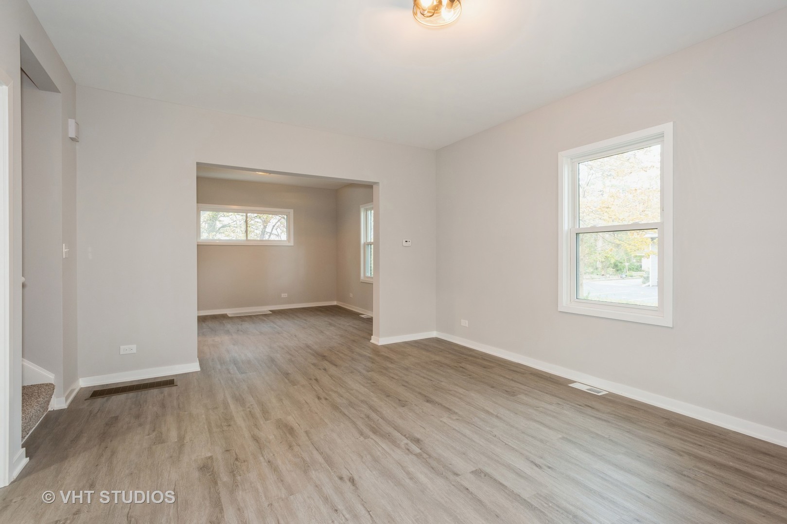 381 Sullivan Road North Aurora, IL 60542 - Photo 8 of 29 an empty room with wooden floor and windows