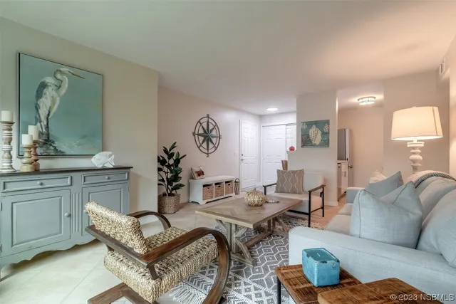 a living room with furniture and a large mirror