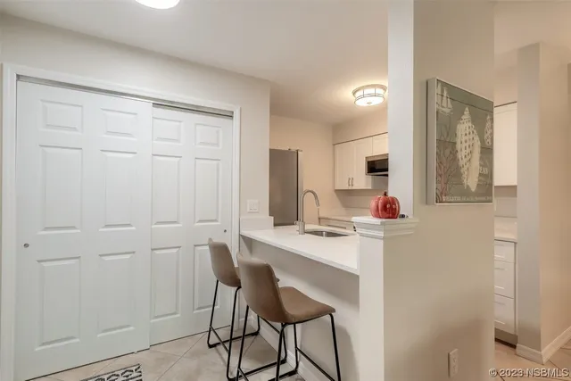 a view of a workspace with furniture and window