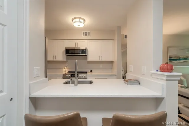 a kitchen with a sink cabinets and appliances