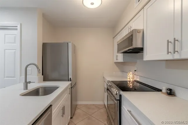a kitchen with stainless steel appliances a sink a stove and a refrigerator
