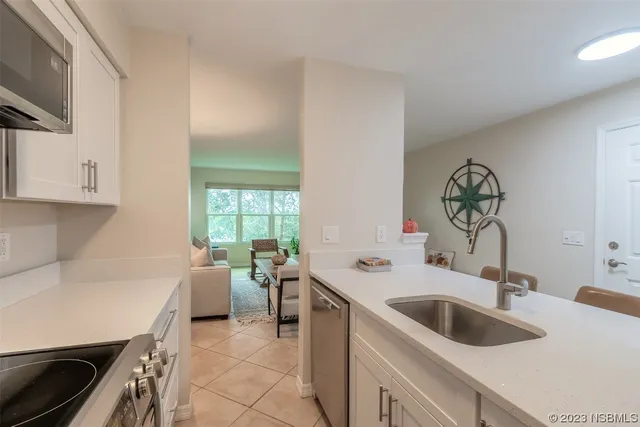 a kitchen with a sink cabinets and a stove
