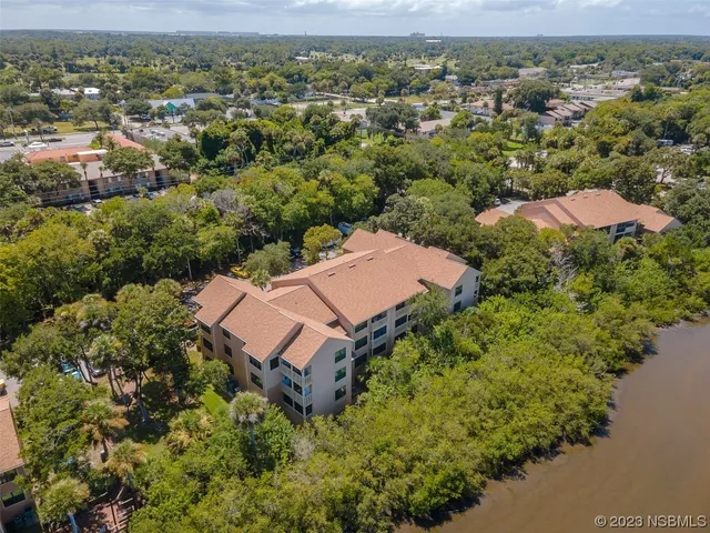 an aerial view of a house with a mountain