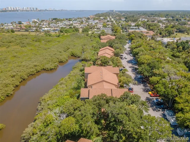 an aerial view of ocean with residential house with outdoor space