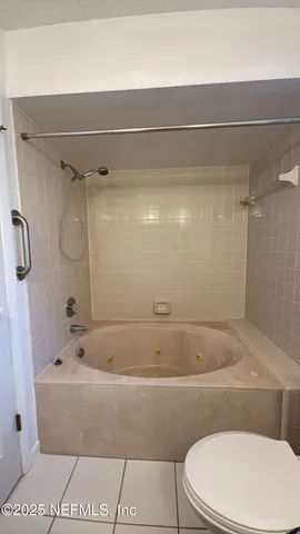 a bathroom with a white toilet and a shower