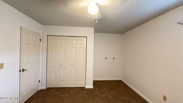 an empty room with closet area