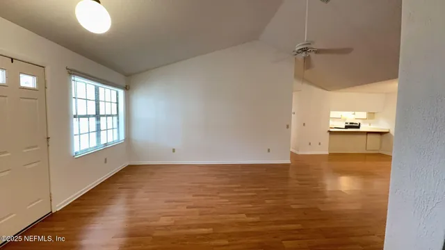 wooden floor in an empty room with a window
