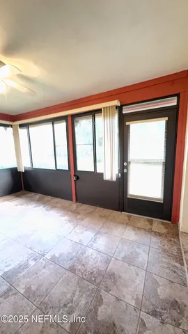 a view of an empty room with a window