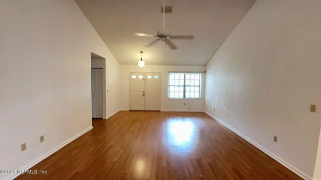 wooden floor in an empty room with a window