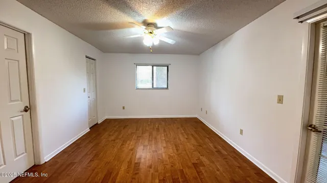 wooden floor in an empty room with a window