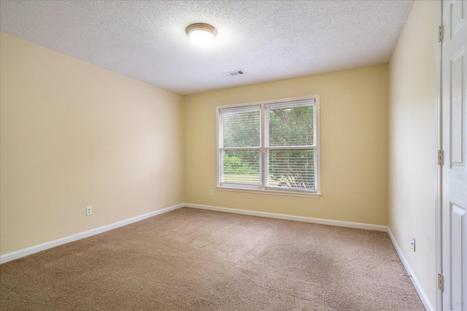 8817 Dexter Road Memphis, TN 38016 - Photo 26 of 34 Carpeted empty room featuring a textured ceiling