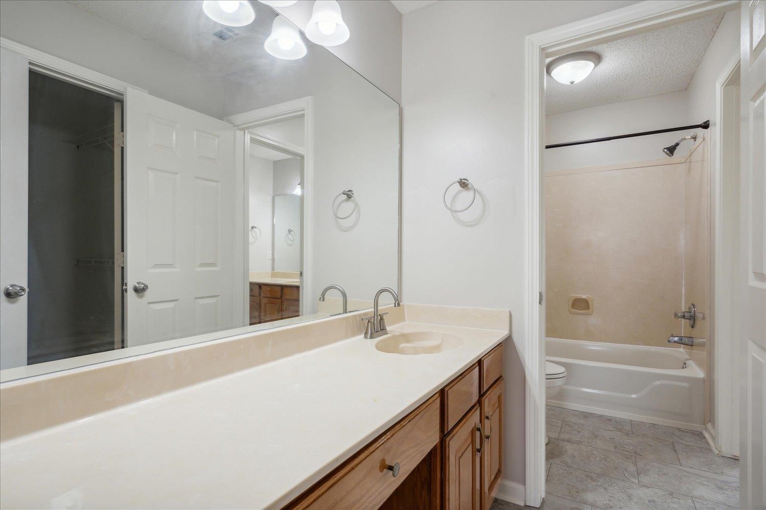 8817 Dexter Road Memphis, TN 38016 - Photo 29 of 34 Full bathroom with tile floors, oversized vanity, toilet, and bathing tub / shower combination