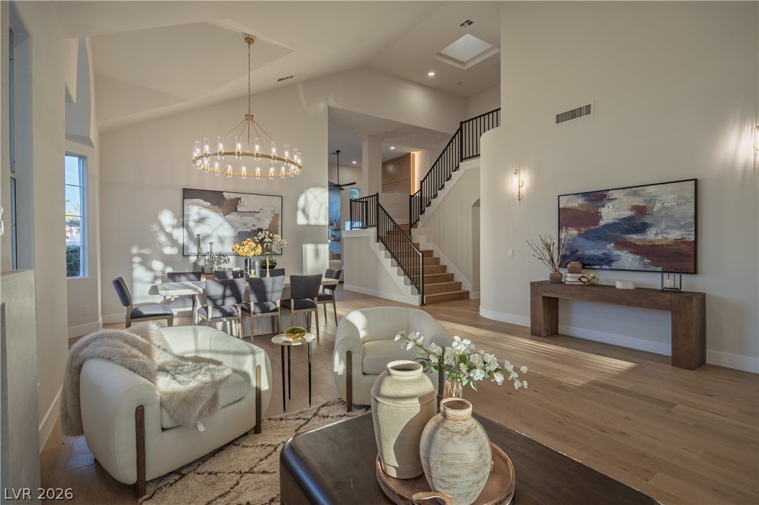 8800 Lusso Las Vegas, NV 89134 - Photo 20 of 85 Living room featuring hardwood / wood-style flooring, hanging lights, and vaulted ceiling