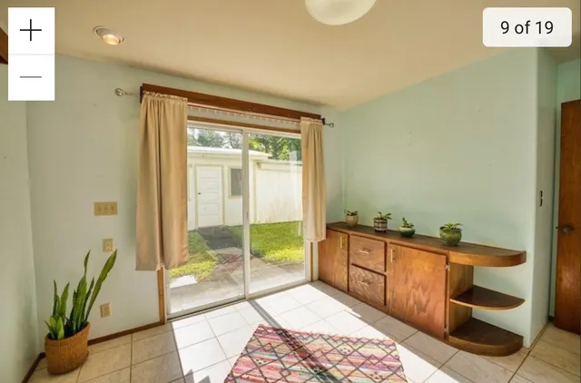 a room with a sink and glass door