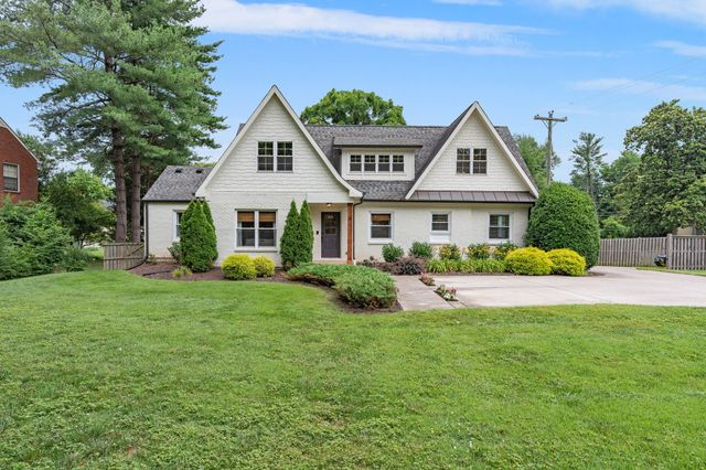 a front view of a house with a yard and porch