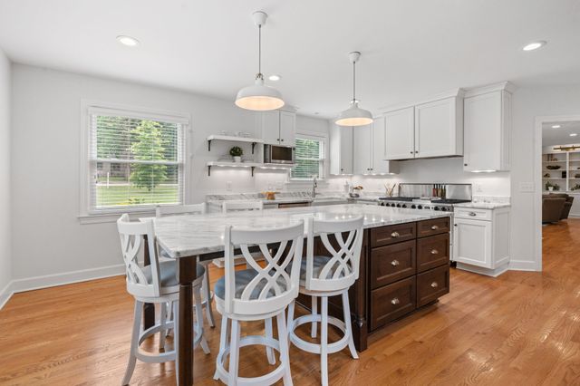 a kitchen with granite countertop wooden cabinets and center island