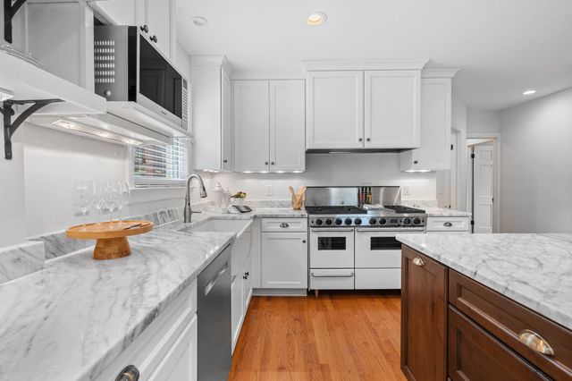 a kitchen with a sink a stove and cabinets