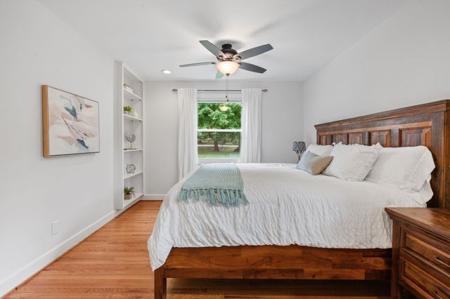 a bedroom with a large bed and a window
