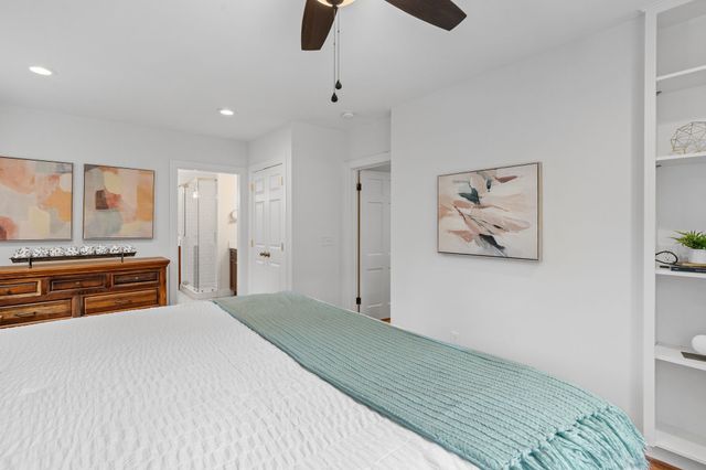 a bedroom with a bed and a large window