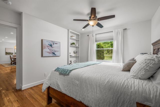 a bedroom with a large bed and a window