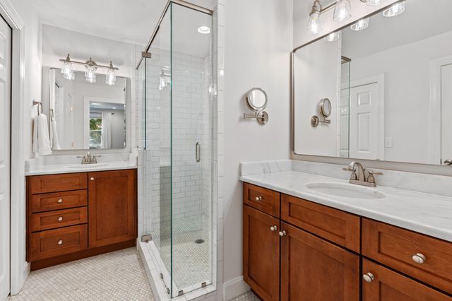 a bathroom with a granite countertop sink mirror and double
