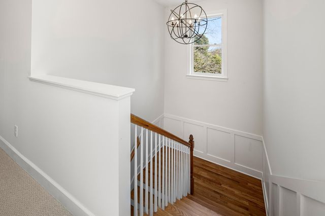 a view of empty room with stairs and windows