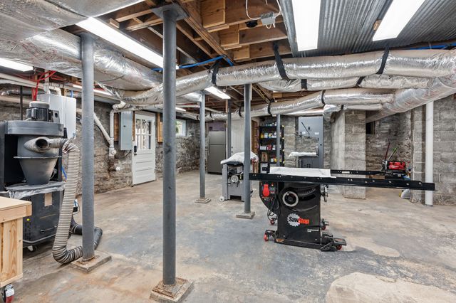 a view of a house with a yard and a patio