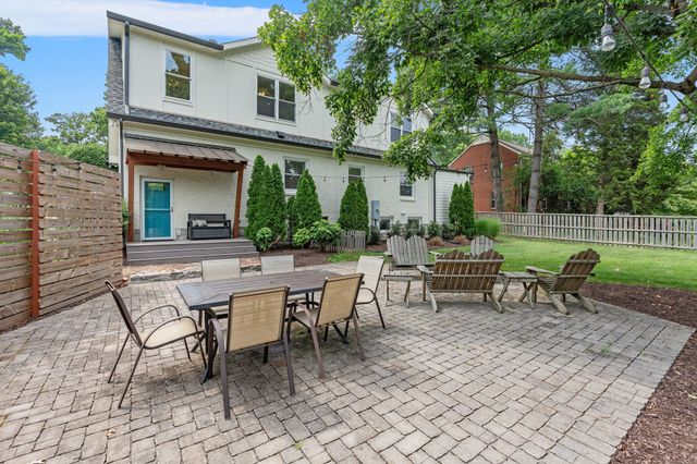 a view of a backyard with sitting area