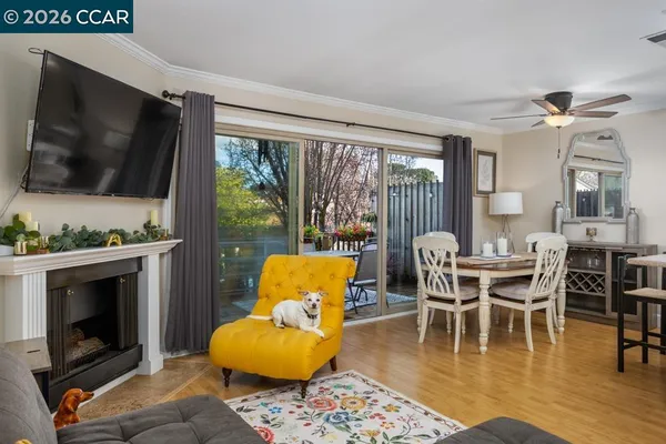 a dining room with furniture wooden floor and a fireplace
