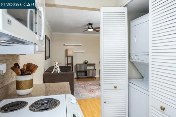 a kitchen with a stove and white cabinets