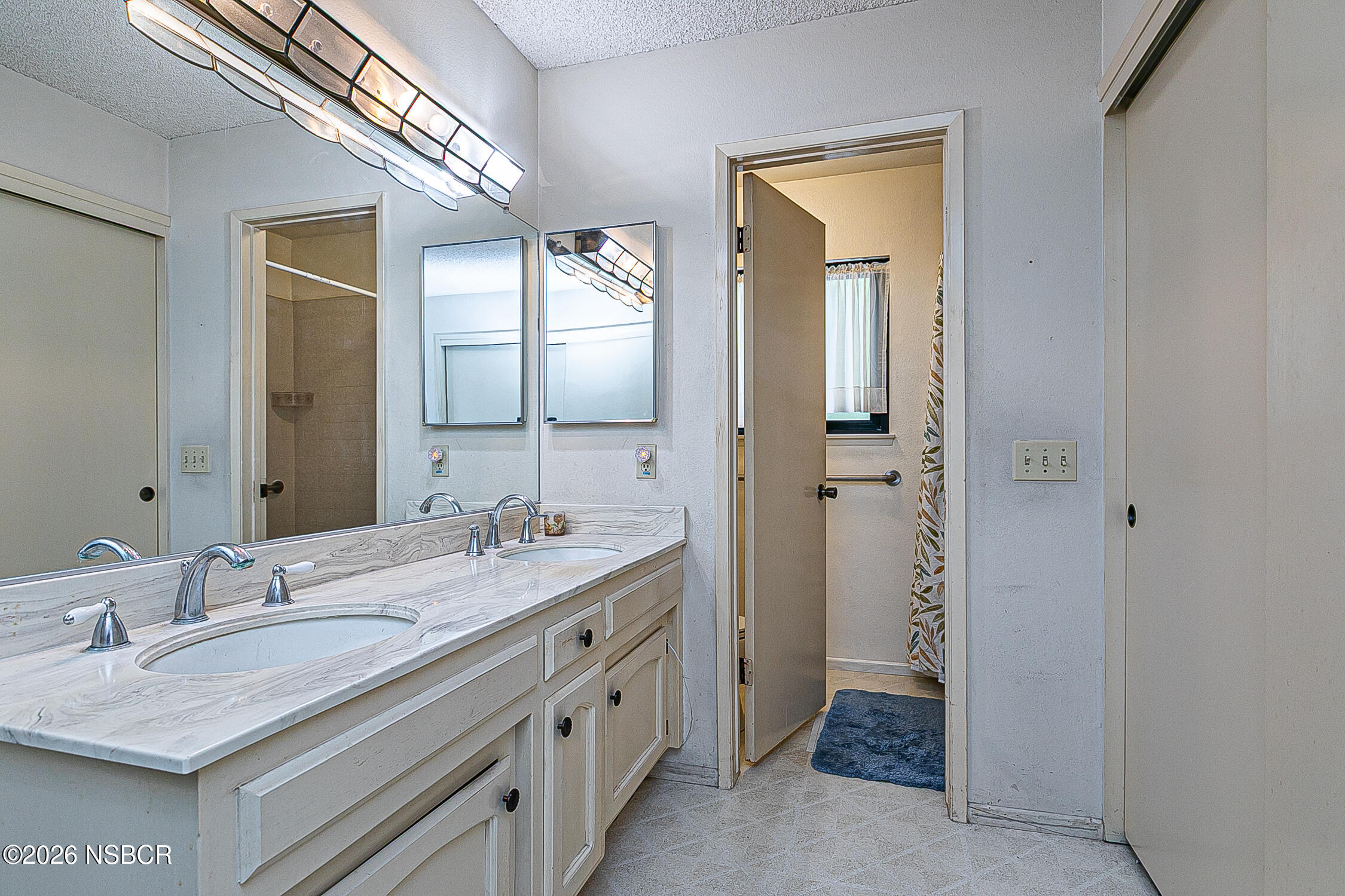 4447 Falcon Drive Lompoc, CA 93436 - Photo 15 of 25 a bathroom with a granite countertop sink mirror and a