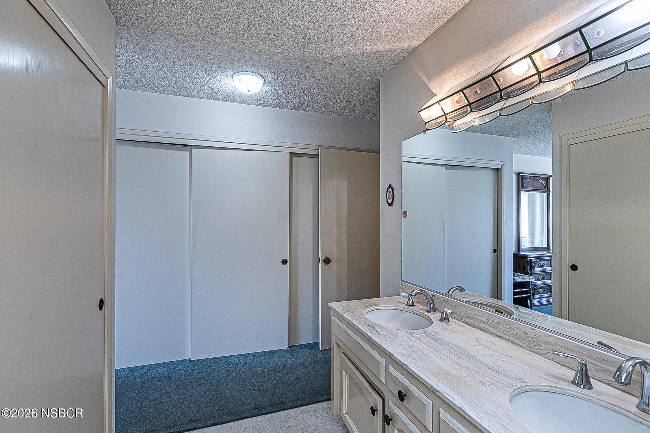 4447 Falcon Drive Lompoc, CA 93436 - Photo 16 of 25 a bathroom with a sink and a mirror