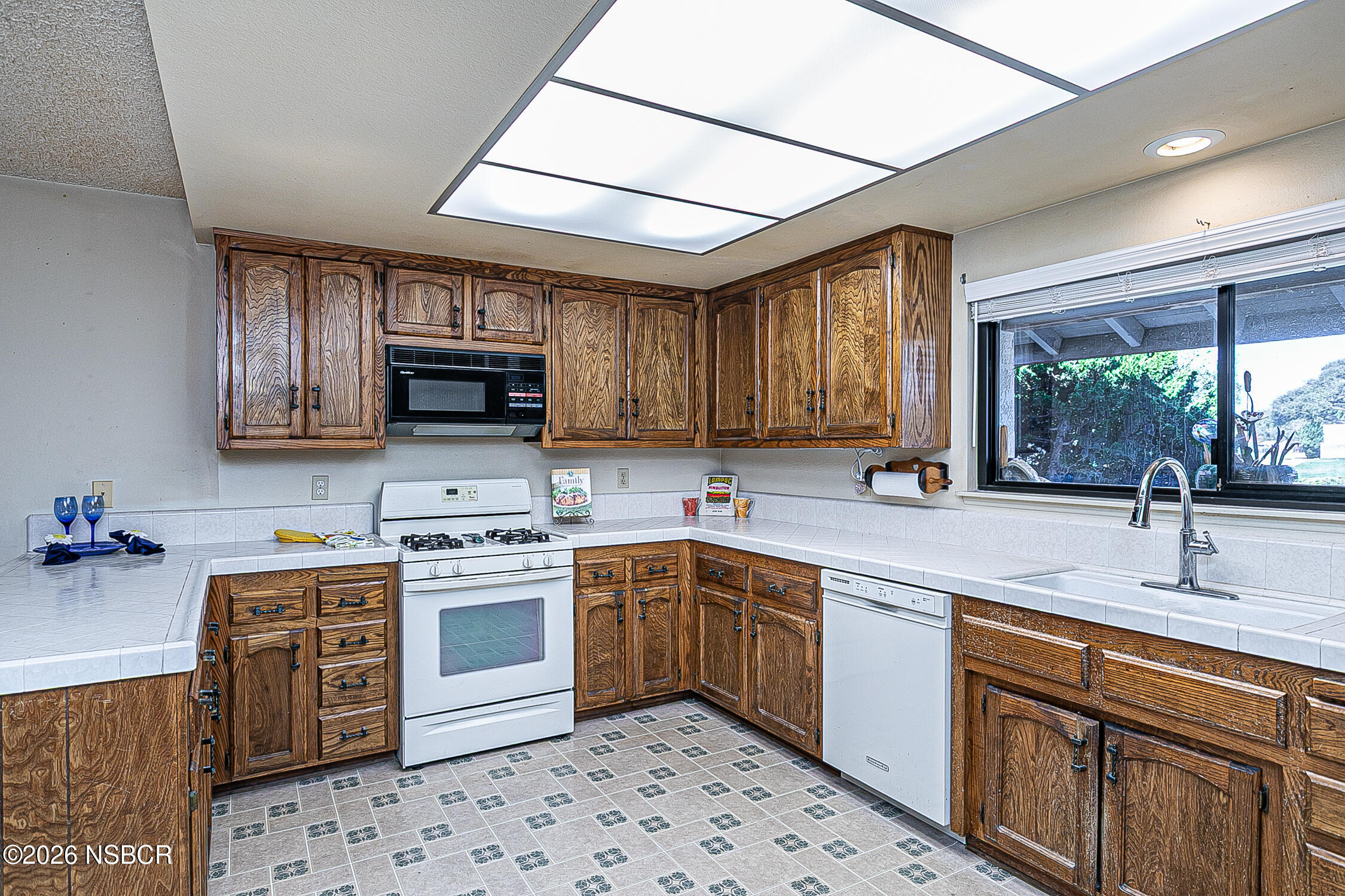 4447 Falcon Drive Lompoc, CA 93436 - Photo 6 of 25 a kitchen with stainless steel appliances sink stove microwave and cabinets