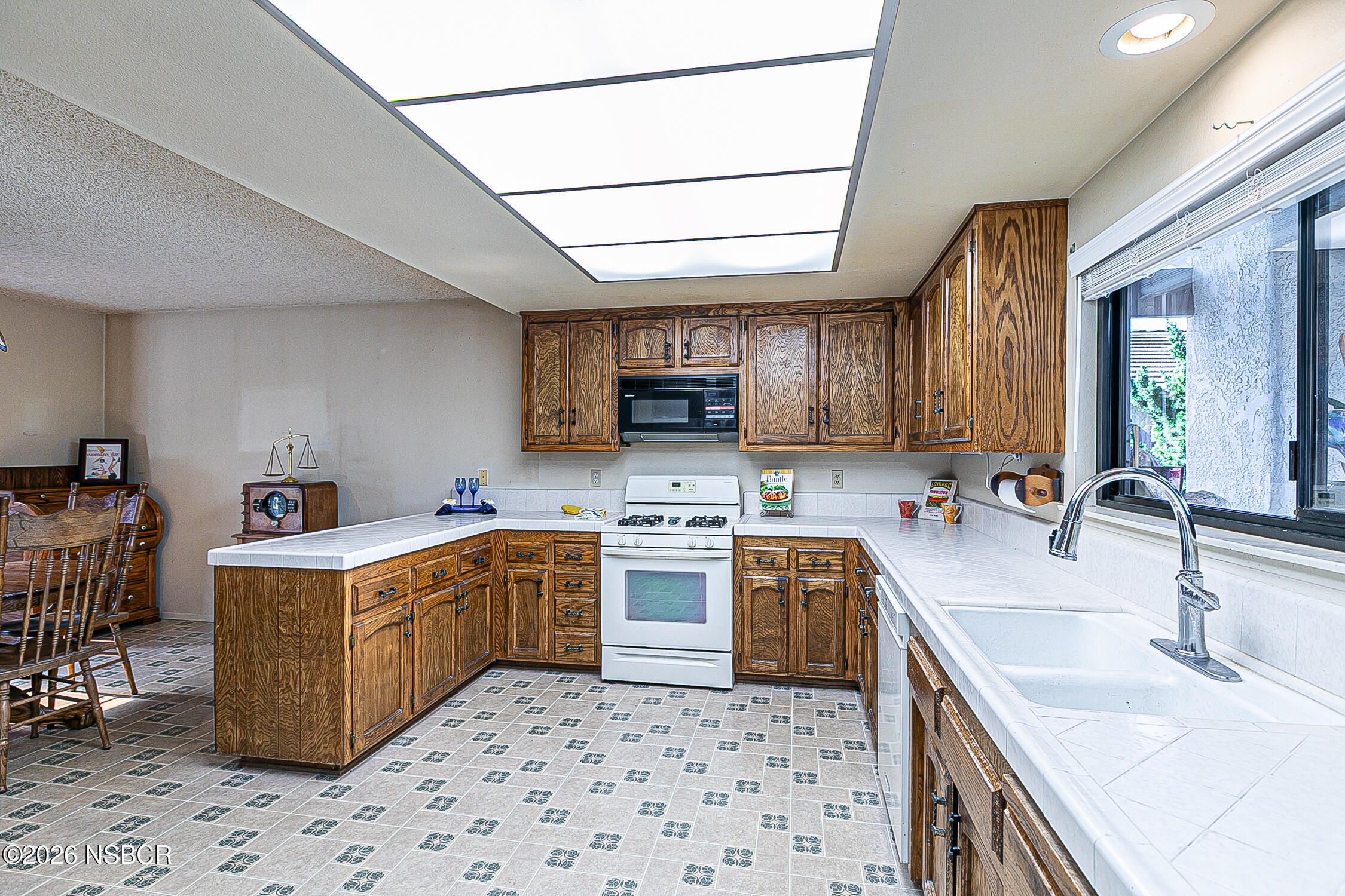 4447 Falcon Drive Lompoc, CA 93436 - Photo 7 of 25 a kitchen with a stove sink and cabinets