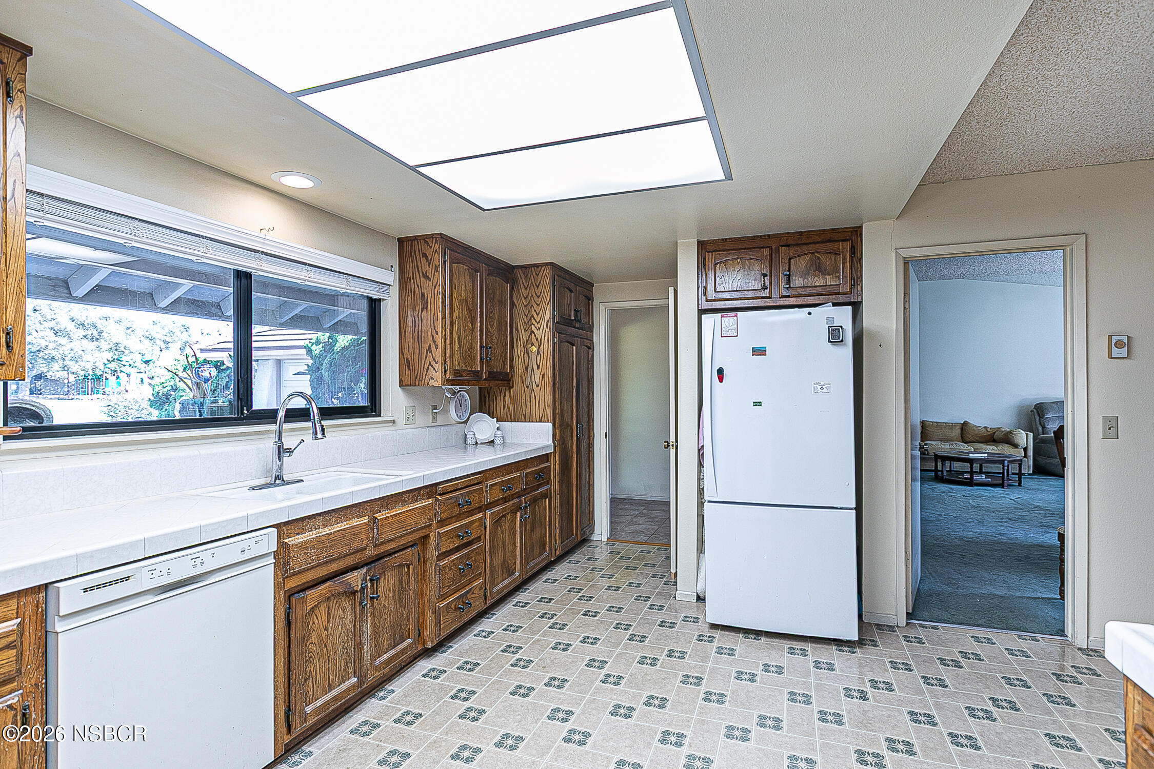 4447 Falcon Drive Lompoc, CA 93436 - Photo 8 of 25 a kitchen with a refrigerator and a sink