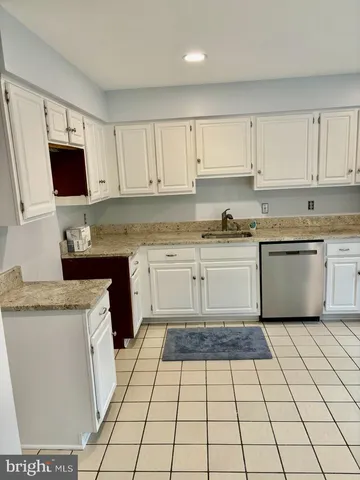 a kitchen with a stove sink and cabinets