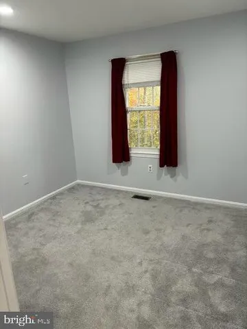 a view of small space with a window and a fan