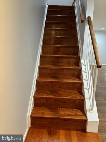 a bathroom with a granite countertop toilet sink and mirror