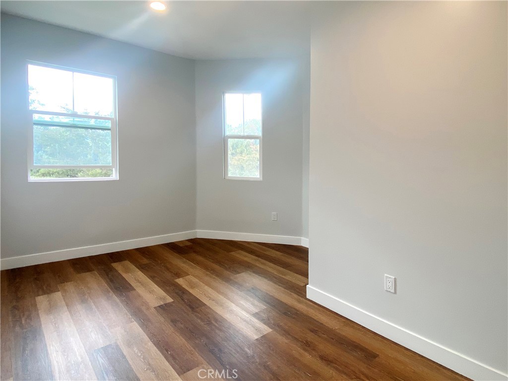 300 East Alhambra Road, Unit E Alhambra, CA 91801 - Photo 12 of 23 an empty room with wooden floor and windows
