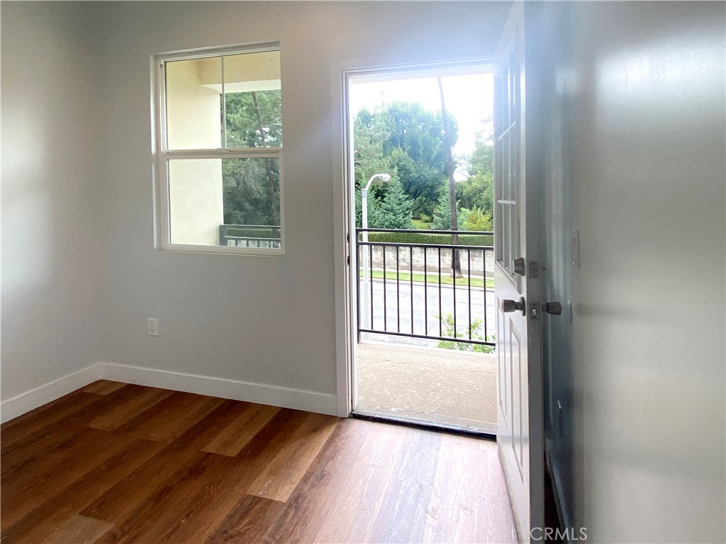 300 East Alhambra Road, Unit E Alhambra, CA 91801 - Photo 14 of 23 an empty room with wooden floor and windows