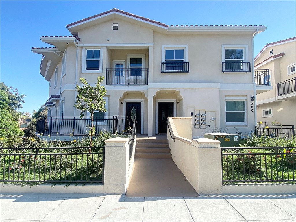300 East Alhambra Road, Unit E Alhambra, CA 91801 - Photo 2 of 23 a front view of a house with a garden