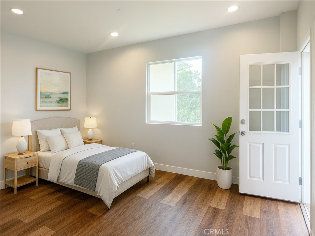 300 East Alhambra Road, Unit E Alhambra, CA 91801 - Photo 7 of 23 a bedroom with a large bed and a wooden floor