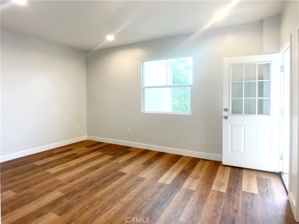 300 East Alhambra Road, Unit E Alhambra, CA 91801 - Photo 8 of 23 an empty room with wooden floor and windows