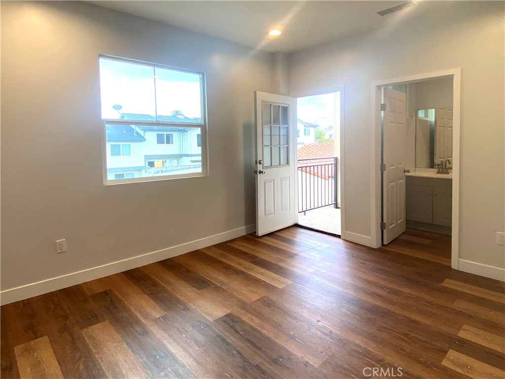 300 East Alhambra Road, Unit E Alhambra, CA 91801 - Photo 10 of 23 an empty room with wooden floor and windows