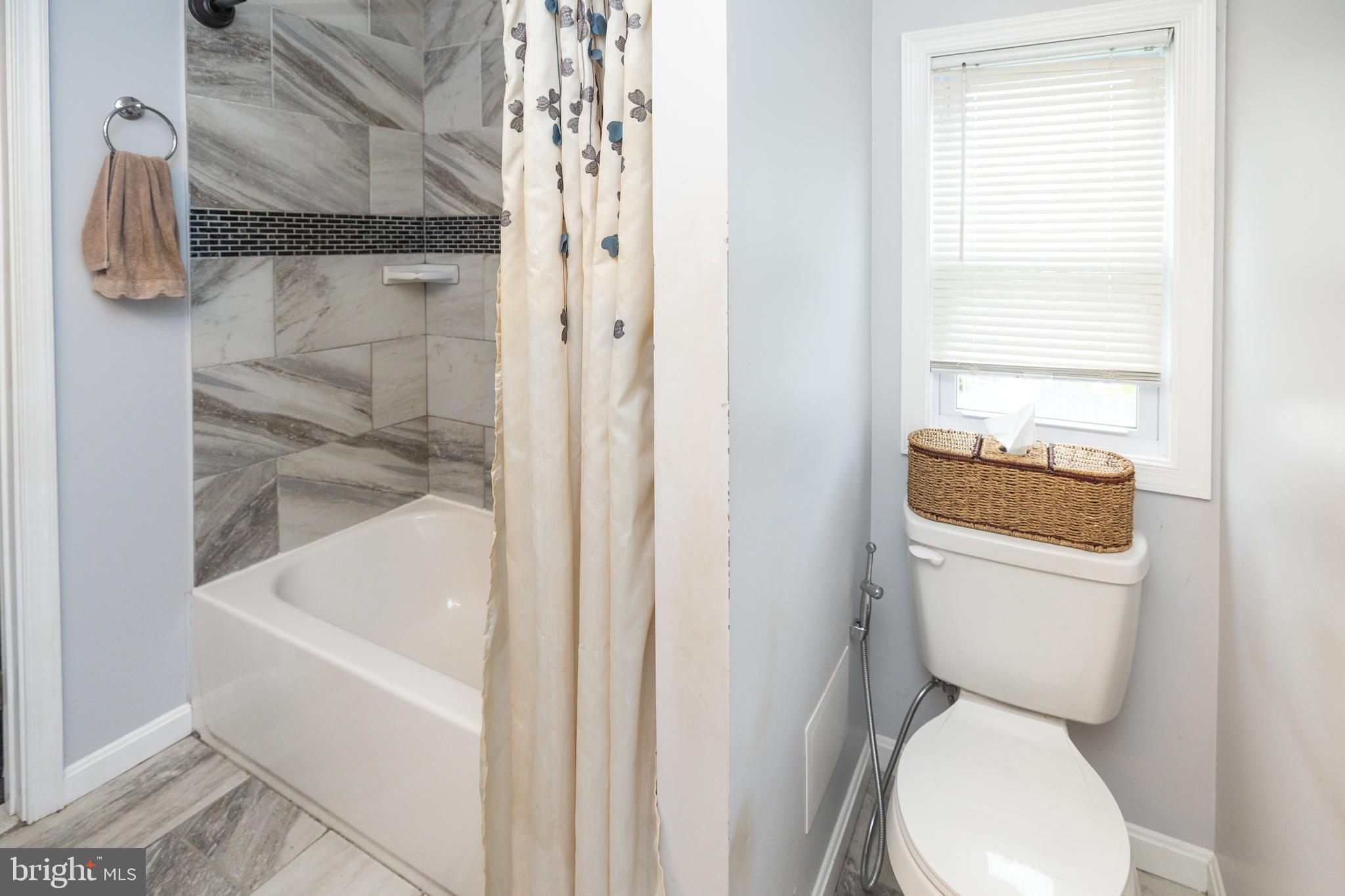 5216 Tramore Road Baltimore, MD 21214 - Photo 14 of 39 a bathroom with a toilet and a shower