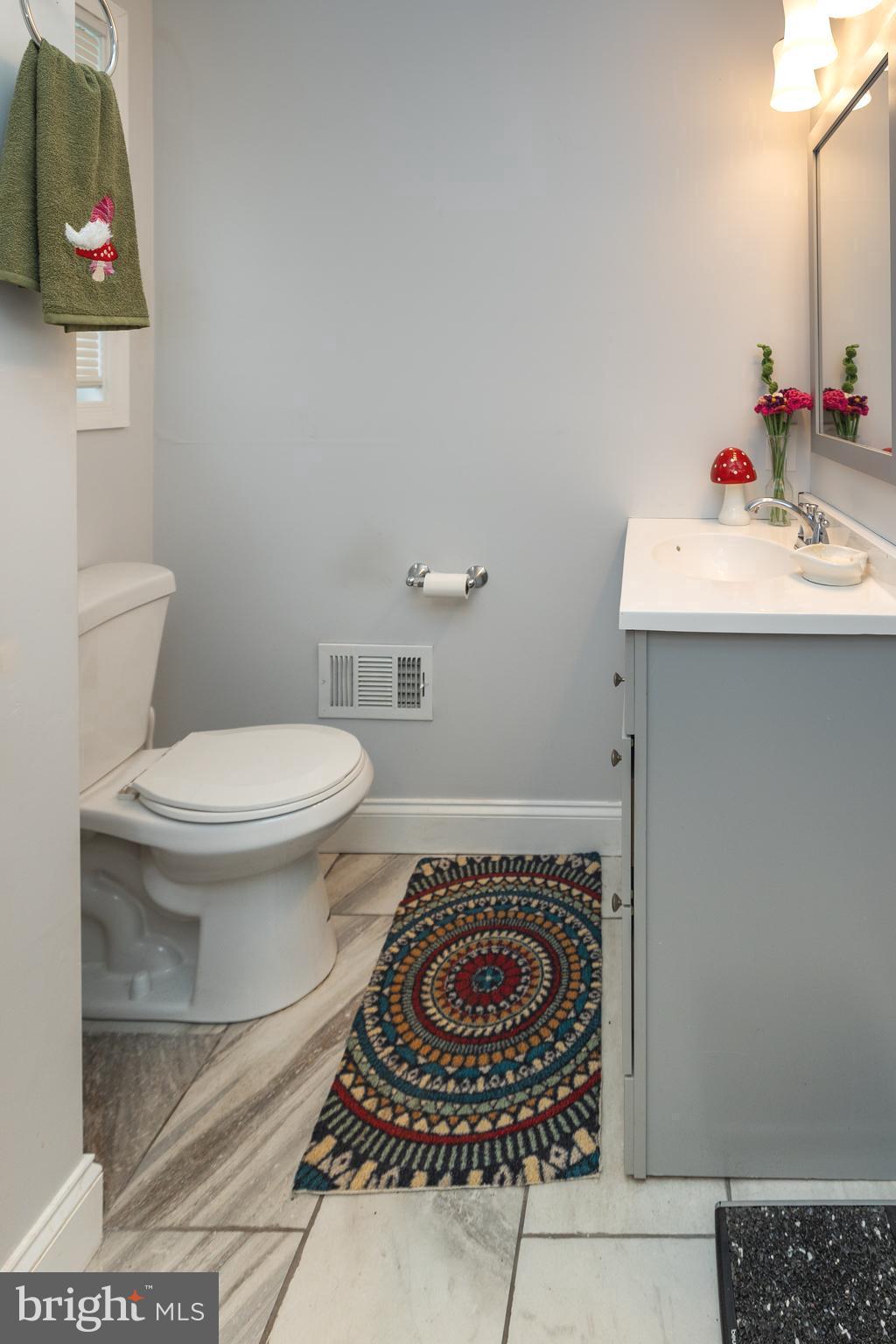 5216 Tramore Road Baltimore, MD 21214 - Photo 15 of 39 a bathroom with a sink and a toilet