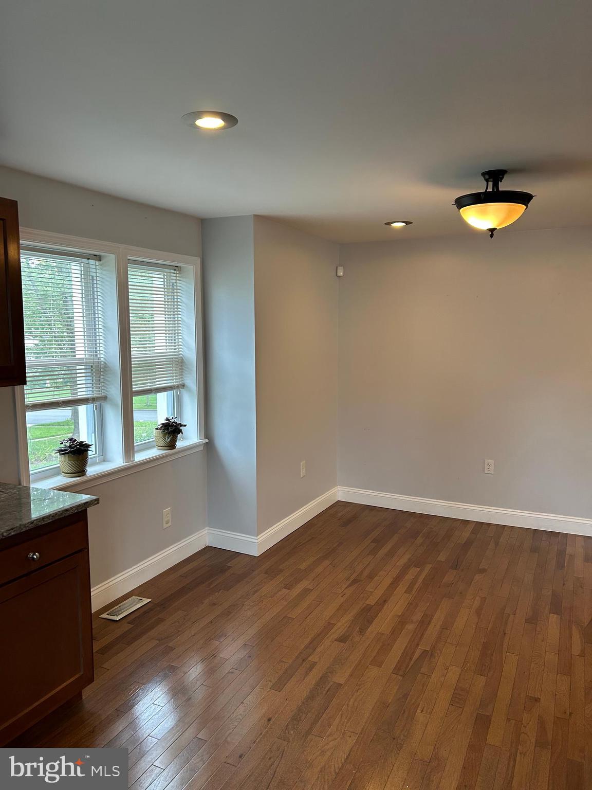 5216 Tramore Road Baltimore, MD 21214 - Photo 20 of 39 wooden floor in an empty room with a window