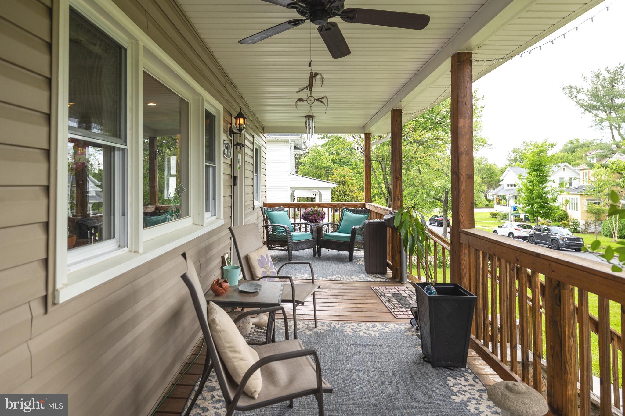 5216 Tramore Road Baltimore, MD 21214 - Photo 28 of 39 a view of a patio with a table chairs and a porch